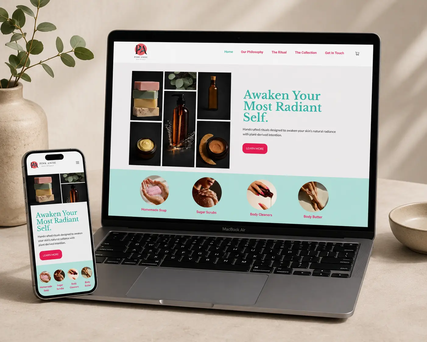 Pink Anise boutique website displayed on laptop and phone